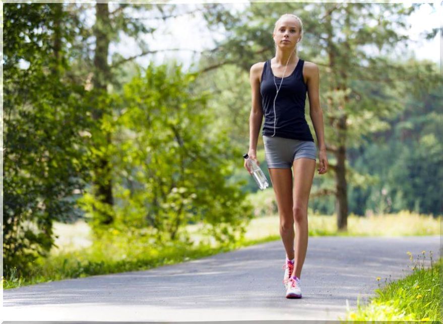 Woman walking with a bottle of water.