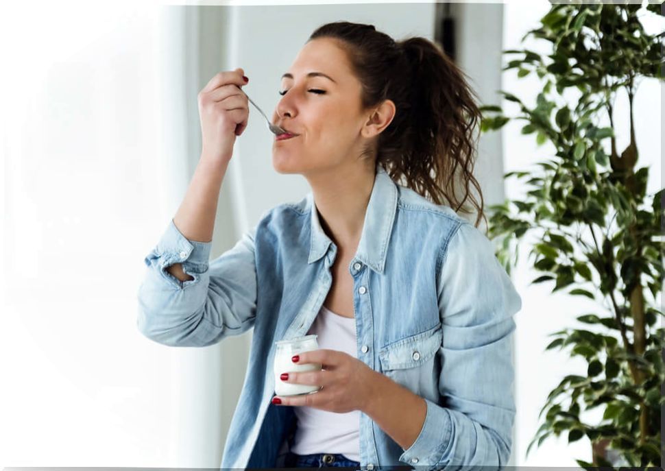 Woman eating a yogurt