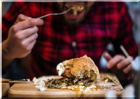 Man eating a hamburger.