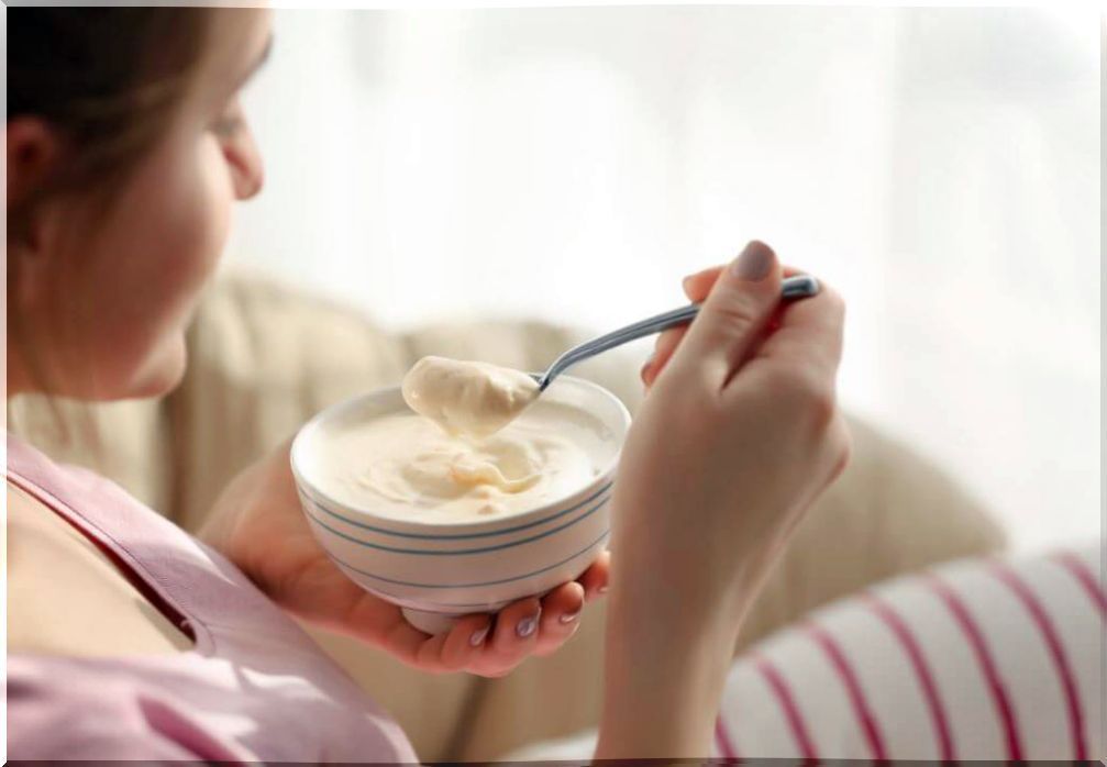 Woman eating yogurt with melon