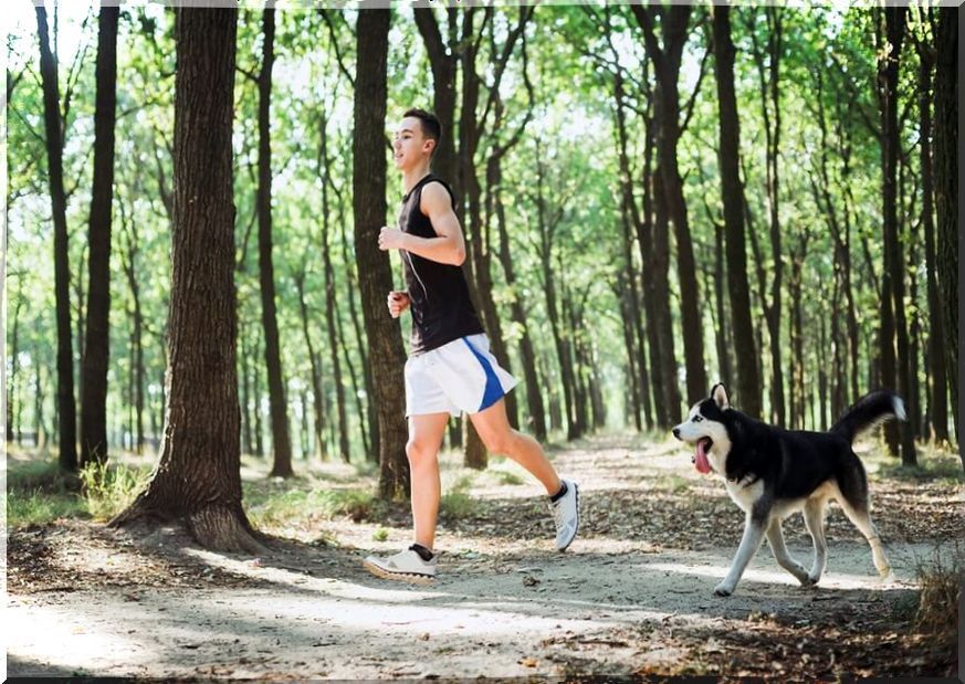 Boy running with his dog