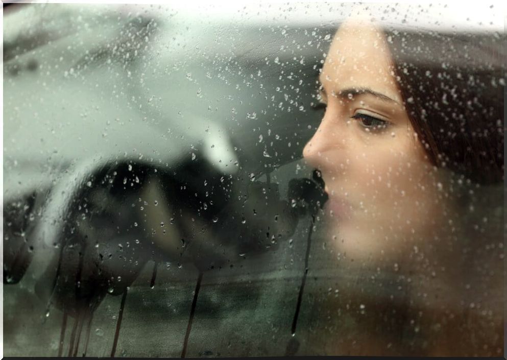 Woman accepting breakup of couple looking out a window