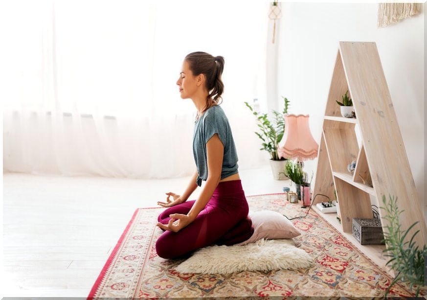 Woman practicing meditation at home.